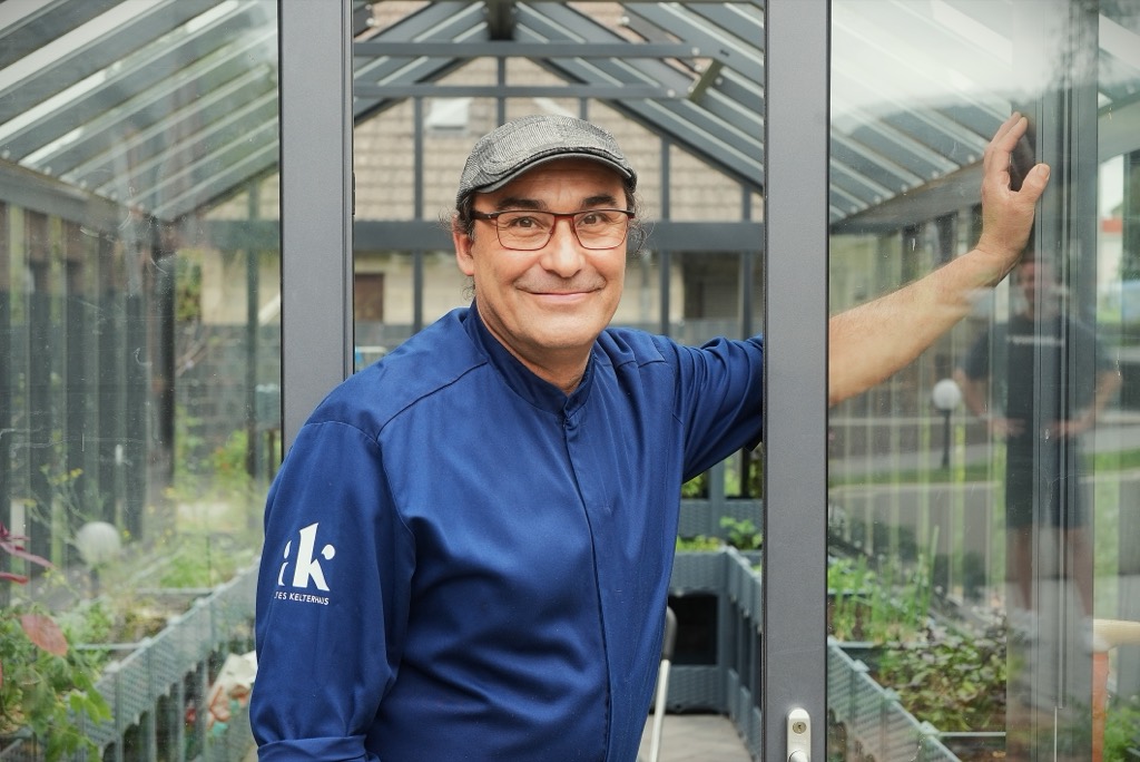 Markus Plein in chef’s whites in the greenhouse